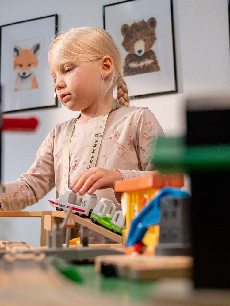 Ein Kind spielt kreativ mit bunten Bausteinen in der betreuten Spielecke des Hotels Vier Jahreszeiten.