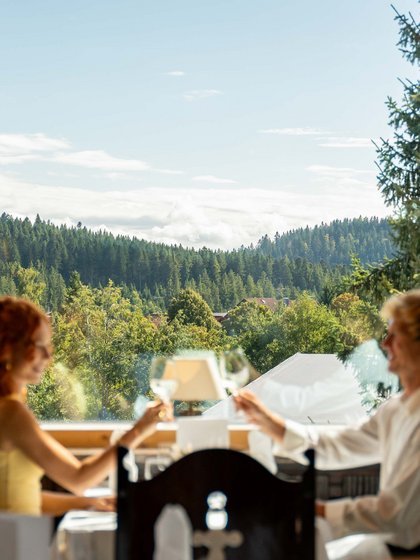Romantisches Dinner bei Sonnenuntergang mit Blick auf die Schwarzwald-Landschaft.