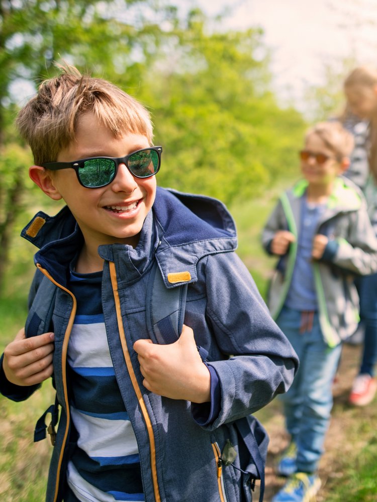 Eine Frau und zwei Jungen laufen durch den Wald