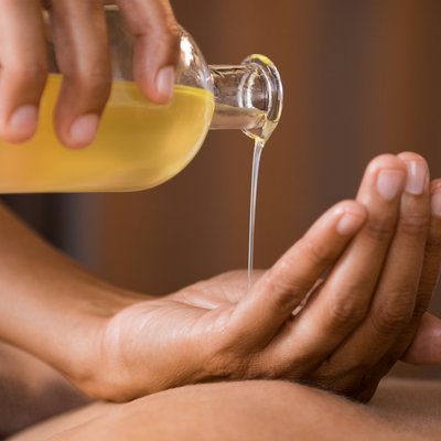 eine Person lässt Öl in Ihre Hand fließen 