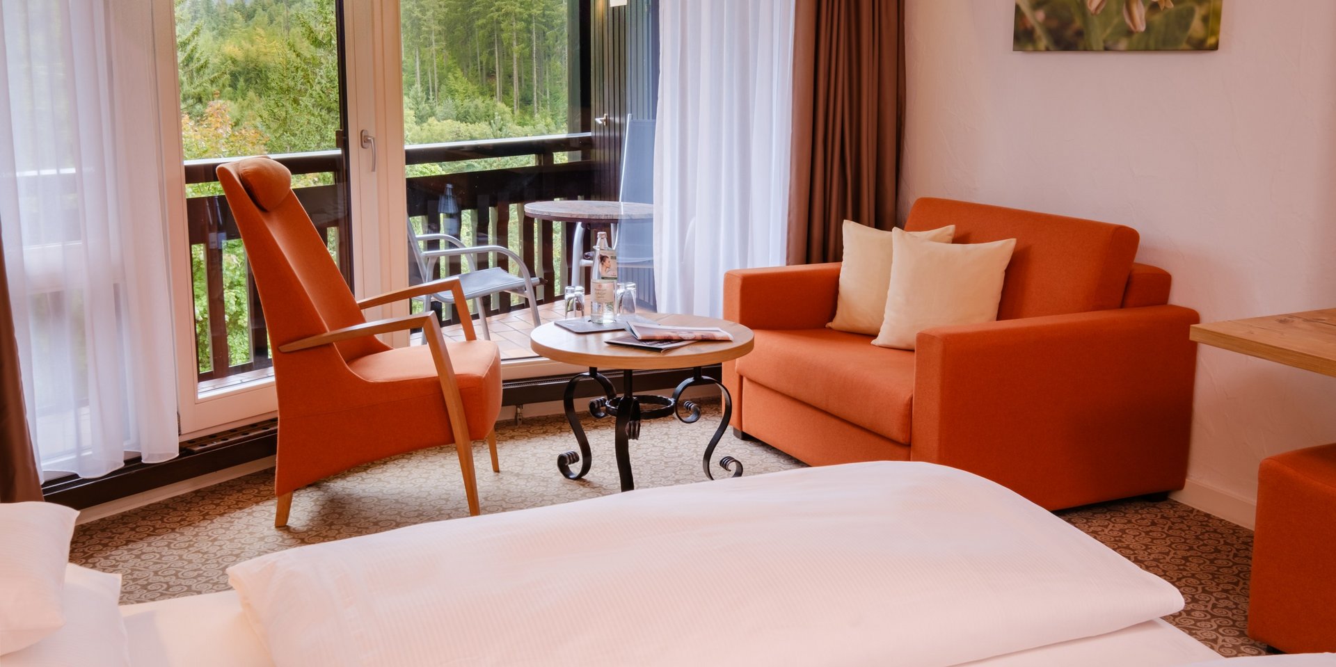 Blick vom Schlafbereich in die gemütliche Sitzecke des Doppelzimmers Klassik Wald.