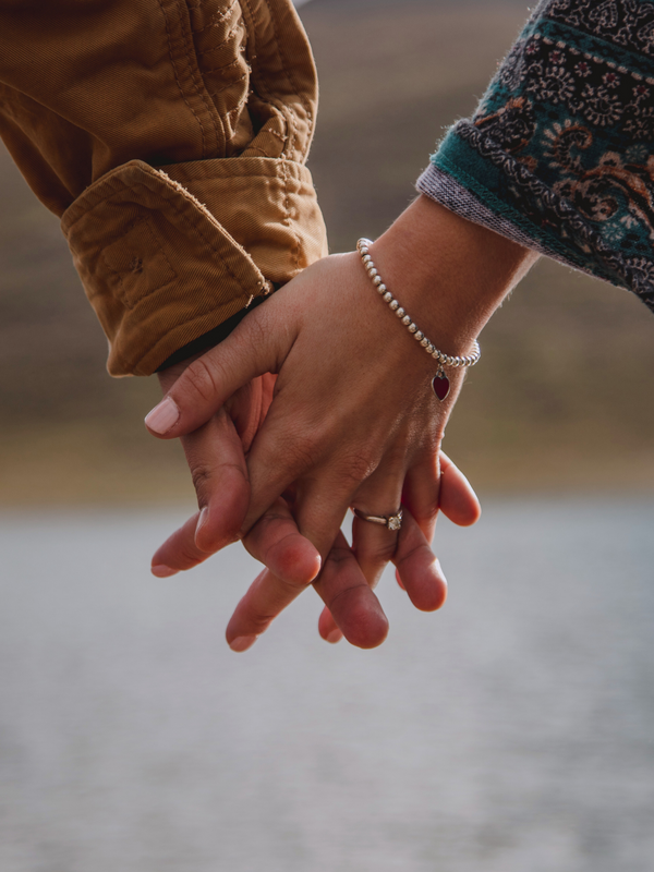 zwei Hände mit den Fingern ineinander verschränkt 