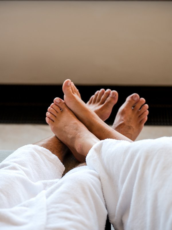 Nahaufnahme der Füße zweier Gäste in der entspannten Atmosphäre des Wellnessbereiches vom Vier Jahreszeiten Hotel am Schluchsee.