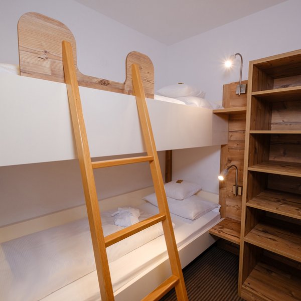 Separater Schlafbereich für Kinder mit einem stabilen Etagenbett aus Naturholz.