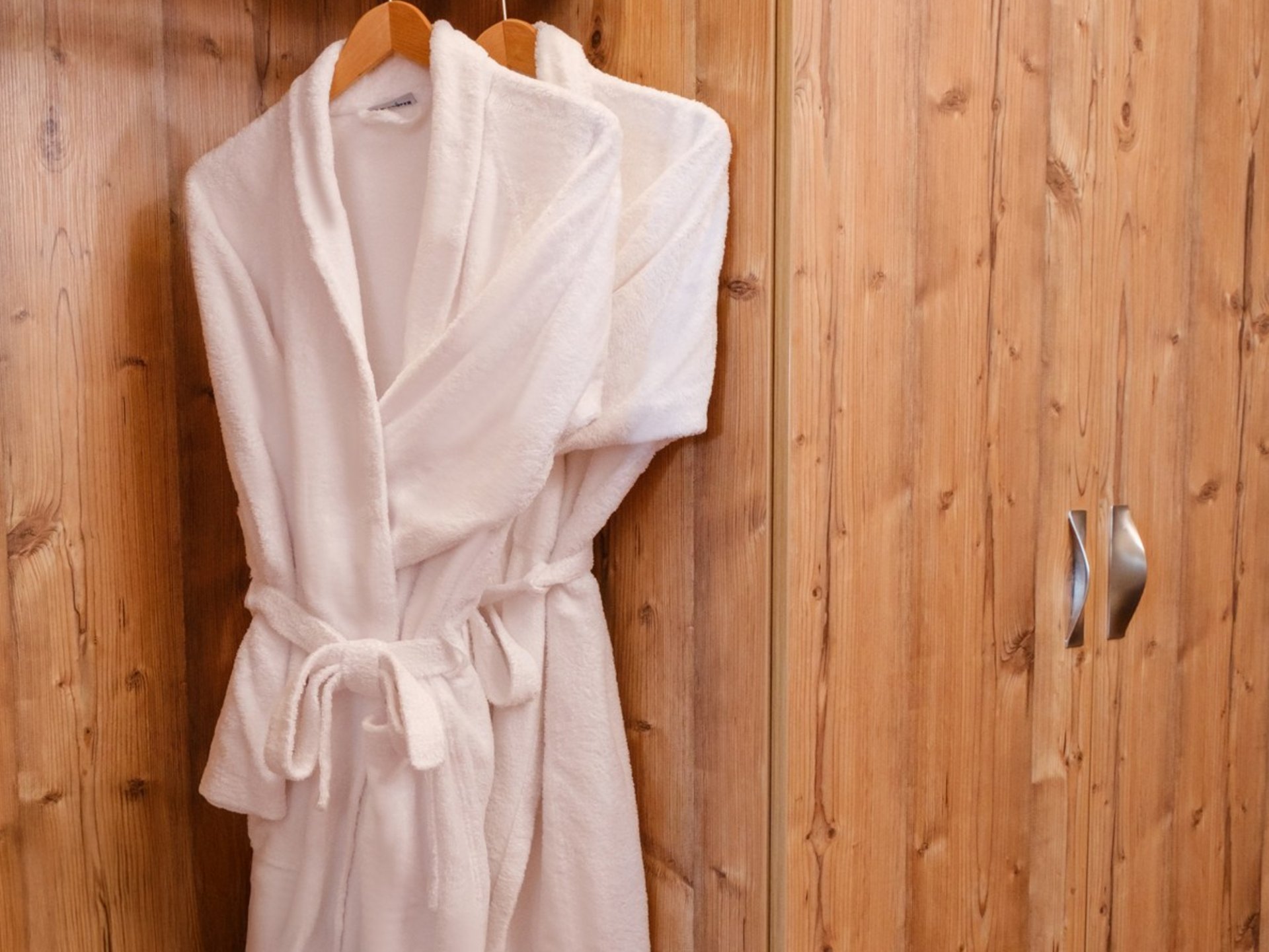 Flauschiger Bademantel im Kleiderschrank vom Hotel Vier Jahreszeiten für Wellnessgäste.