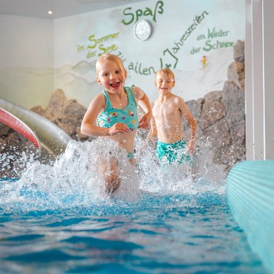 Kinder planschen vergnügt im flachen Wasser des Hallenbades im Hotel Vier Jahreszeiten am Schluchsee.
